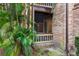 View of a screened in porch with white railings and a brick wall at 490 N Pin Oak Pl # 112, Longwood, FL 32779