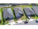 Enjoy this aerial view of the neighborhood, with well-spaced homes, sidewalks and solar panels at 670 Campo Ln, Davenport, FL 33837