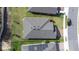 An aerial view of a well-maintained property showcasing its roof, yard, and proximity to the street at 670 Campo Ln, Davenport, FL 33837