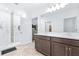 Elegant bathroom featuring a double vanity, large mirror, and a walk-in shower at 670 Campo Ln, Davenport, FL 33837