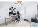 Bright bedroom features sound proofing and a desk with three monitors at 670 Campo Ln, Davenport, FL 33837