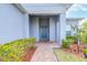 Beautiful front entryway with a decorative front door, manicured bushes, and a brick walkway at 670 Campo Ln, Davenport, FL 33837