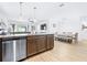 Modern kitchen featuring stainless steel appliances, granite countertops, and a dining area at 670 Campo Ln, Davenport, FL 33837