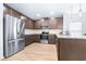 Stylish kitchen with wood cabinetry, stainless steel appliances, and wood flooring, offering a sleek design at 670 Campo Ln, Davenport, FL 33837
