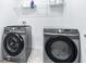 Bright laundry room features a washer and dryer and lots of shelving space at 670 Campo Ln, Davenport, FL 33837