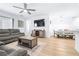 Open concept living room, with kitchen, dining area, and large sectional couch at 670 Campo Ln, Davenport, FL 33837