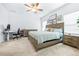 Spacious main bedroom with lots of natural light, neutral walls, and a ceiling fan at 670 Campo Ln, Davenport, FL 33837