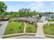 Beautifully landscaped home has great curb appeal with lush lawn, mature trees, and paved driveway at 114 Valencia Loop, Altamonte Springs, FL 32714