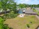 A sprawling yard with mature trees, a screened pool and a cozy fire pit area can be seen at 114 Valencia Loop, Altamonte Springs, FL 32714