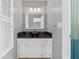 Bathroom featuring modern vanity with black countertop and framed mirror at 114 Valencia Loop, Altamonte Springs, FL 32714