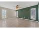 Open bedroom with fan, tile floor, and shuttered windows providing natural light at 114 Valencia Loop, Altamonte Springs, FL 32714