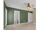 Bedroom with fan, tile floor, shuttered windows and doorway to bathroom at 114 Valencia Loop, Altamonte Springs, FL 32714