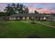 Beautiful single-story home at twilight with lush landscaping, a well-manicured lawn, and inviting walkway at 114 Valencia Loop, Altamonte Springs, FL 32714