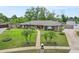 Well-manicured front yard with lush landscaping and a charming walkway leading to the front door at 114 Valencia Loop, Altamonte Springs, FL 32714