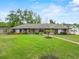 Well-manicured lawn showcasing a charming single-story home with meticulously landscaped front yard and walkway at 114 Valencia Loop, Altamonte Springs, FL 32714