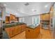 Spacious kitchen featuring wood cabinets, a central island cooktop, and black countertops at 114 Valencia Loop, Altamonte Springs, FL 32714