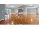 Spacious living room with hardwood floors leading to the kitchen and lanai at 114 Valencia Loop, Altamonte Springs, FL 32714