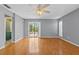 Main bedroom featuring hardwood floors, access to the lanai, and neutral walls at 114 Valencia Loop, Altamonte Springs, FL 32714