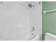 Shower with sleek fixtures, hexagonal tile surround, and contrasting green wall at 114 Valencia Loop, Altamonte Springs, FL 32714