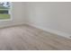 Spacious bedroom with wood-look floors and window overlooking the yard at 16538 Sw 31St Terrace, Ocala, FL 34473