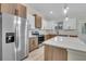 Bright and airy kitchen featuring sleek countertops, stainless steel refrigerator, and contemporary cabinetry at 16538 Sw 31St Terrace, Ocala, FL 34473