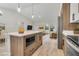 Stylish kitchen with a center island and stainless steel appliances, flowing seamlessly into the living area at 16538 Sw 31St Terrace, Ocala, FL 34473
