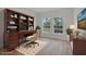 Well-appointed office space featuring a large wooden desk, built-in bookcase, and bright natural light at 16538 Sw 31St Terrace, Ocala, FL 34473