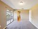 Bedroom with sliding glass doors leading to a balcony and neutral carpet flooring at 2500 21St Nw St # 71, Winter Haven, FL 33881