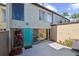 Charming townhouse with a blue door, private patio, and lush tropical landscaping at 2500 21St Nw St # 71, Winter Haven, FL 33881