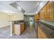 Kitchen featuring stainless appliances, decorative granite countertops, and a bar that overlooks dining area at 2500 21St Nw St # 71, Winter Haven, FL 33881