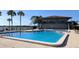 Community pool and spa with nearby clubhouse and lake views at 2500 21St Nw St # 71, Winter Haven, FL 33881