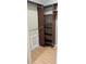 Walk-in closet with custom wood shelves, wooden flooring and hanging rods at 2500 21St Nw St # 71, Winter Haven, FL 33881
