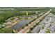 Aerial view showing home with screened pool, and other well-maintained houses near a large pond at 10292 Kristen Park Dr, Orlando, FL 32832