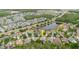 This aerial view shows a home near a pond and highway, nestled in a suburban community with mature trees at 10292 Kristen Park Dr, Orlando, FL 32832