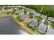 This aerial shows the property nestled near a pond, surrounded by beautiful houses and mature trees at 10292 Kristen Park Dr, Orlando, FL 32832