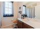 Bathroom with a single sink vanity and window, offering natural light and storage at 10292 Kristen Park Dr, Orlando, FL 32832