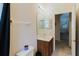 Well-lit bathroom with a vanity, a toilet, and a towel rack next to an open doorway at 10292 Kristen Park Dr, Orlando, FL 32832