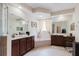 Spacious bathroom featuring double vanities, soaking tub, and decorative details at 10292 Kristen Park Dr, Orlando, FL 32832