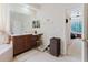 Bathroom with a large mirror, vanity, and an open doorway to another room at 10292 Kristen Park Dr, Orlando, FL 32832