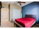Bedroom featuring a modern bed frame, blue accent wall, and large closet at 10292 Kristen Park Dr, Orlando, FL 32832