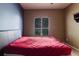 Bedroom with a modern bed frame, window with blinds, and neutral colored walls at 10292 Kristen Park Dr, Orlando, FL 32832