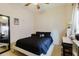 Neutral bedroom features a black comforter, ceiling fan, and window with curtains at 10292 Kristen Park Dr, Orlando, FL 32832