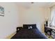 Neutral bedroom features a black comforter, window with curtains and a side table at 10292 Kristen Park Dr, Orlando, FL 32832