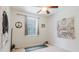 Minimalist bedroom with a large window, ceiling fan, and unique wall tapestries at 10292 Kristen Park Dr, Orlando, FL 32832