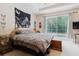 Bright bedroom with sliding glass doors, a decorative tapestry and natural light at 10292 Kristen Park Dr, Orlando, FL 32832