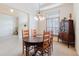 Dining room featuring a wood table, adjacent rooms, and a large window at 10292 Kristen Park Dr, Orlando, FL 32832