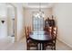 Cozy dining area with a wooden table, cabinet, and plantation shutters on the window at 10292 Kristen Park Dr, Orlando, FL 32832