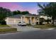 Inviting single-story home featuring stately columns, lush landscaping, and an attached two-car garage at 10292 Kristen Park Dr, Orlando, FL 32832