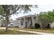 Charming single-story home with columns, a well-manicured lawn, and a three-car garage at 10292 Kristen Park Dr, Orlando, FL 32832