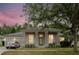 Inviting single-story home featuring stately columns, lush landscaping, and an attached two-car garage at 10292 Kristen Park Dr, Orlando, FL 32832